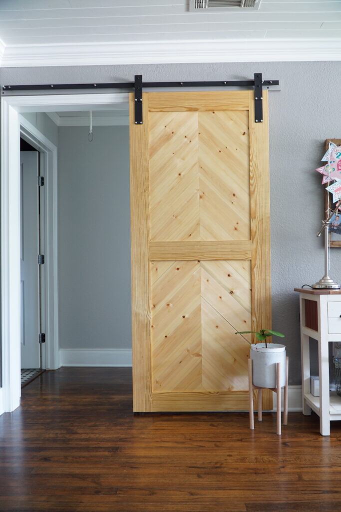 Herringbone barn door used for a hallway opening.