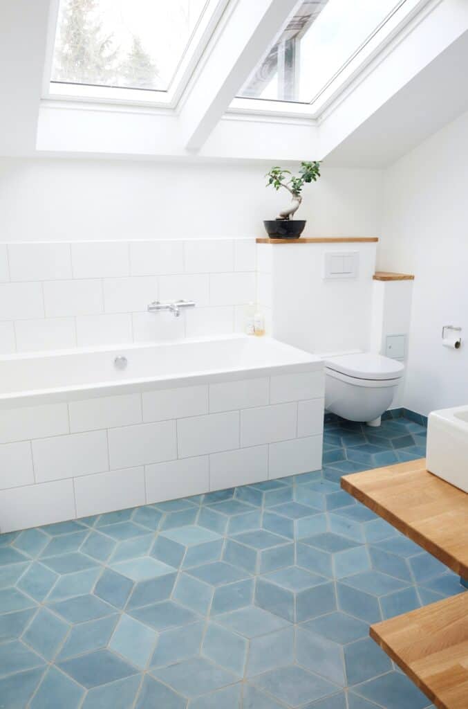 Bathroom with light blue floor tile and white walls and bathroom features
